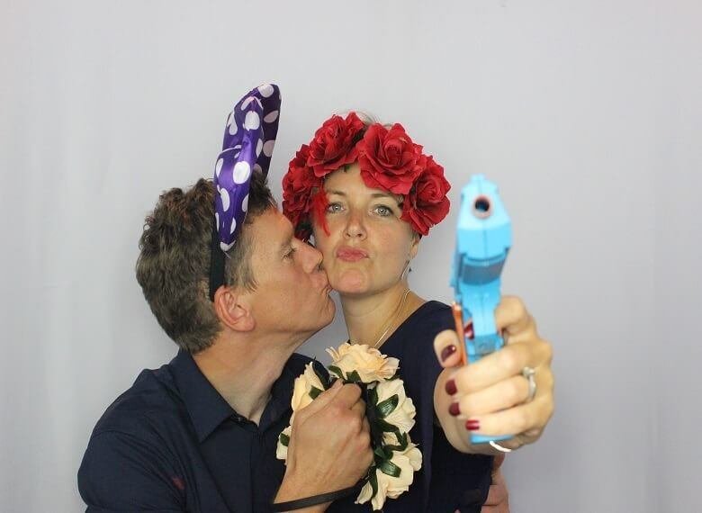 Guests posing with fun photo booth props